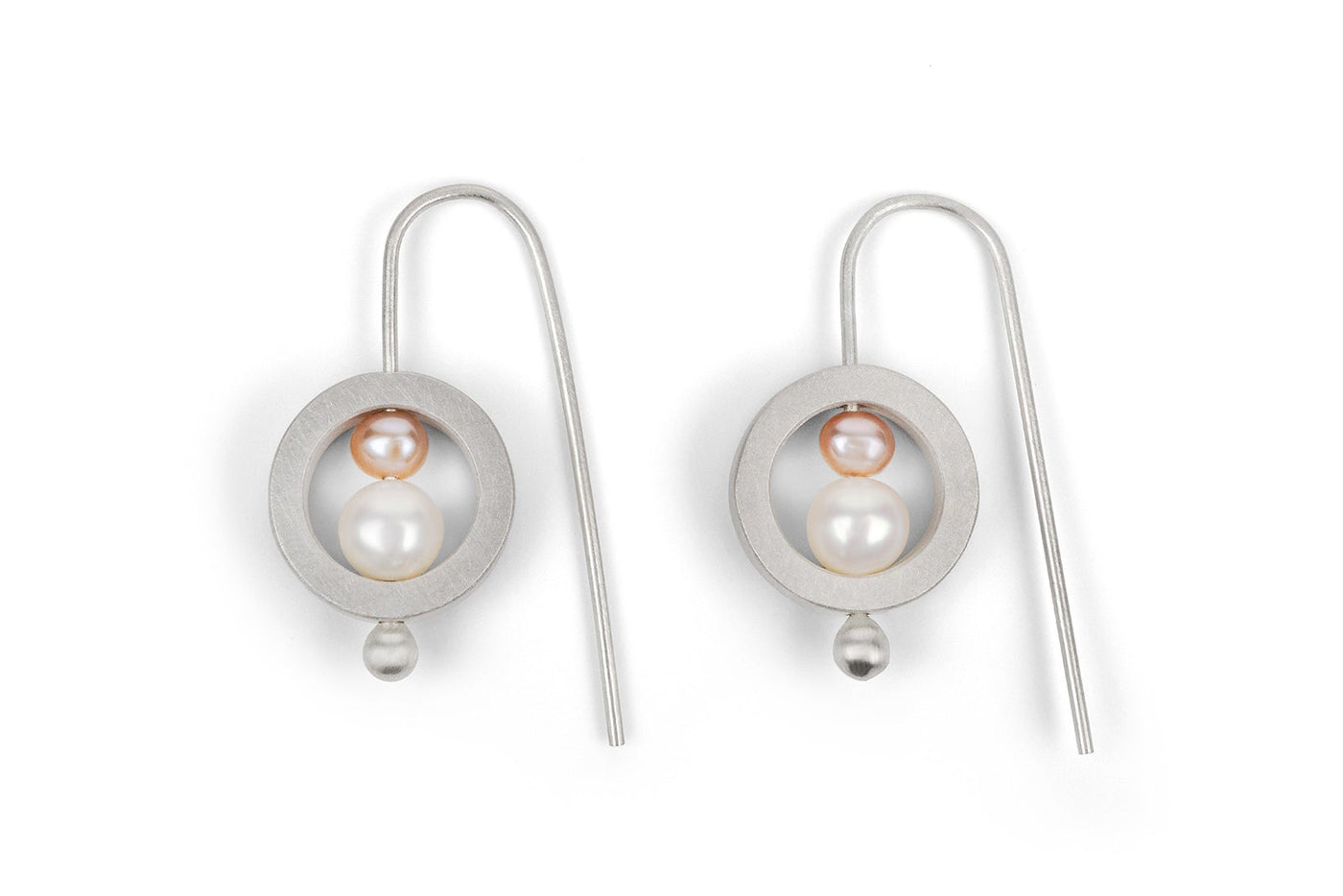Pair of silver earrings with a central pearl on a white background